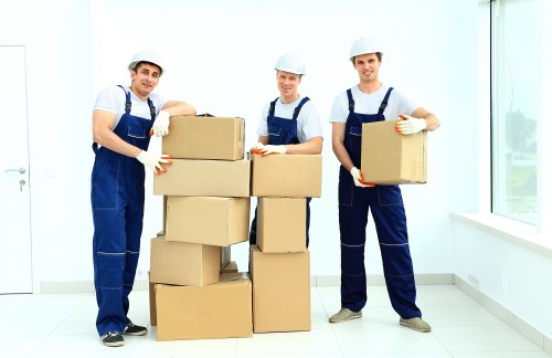 Professional movers unloading items at a West London property