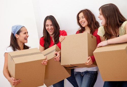 Removal team carrying furniture through a Notting Hill property