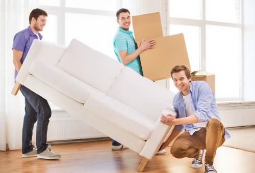 House moving team handling furniture and boxes in a suburban home