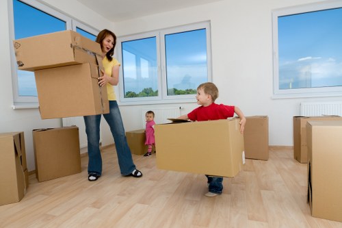 Movers handling furniture in a Notting Hill flat with tight access